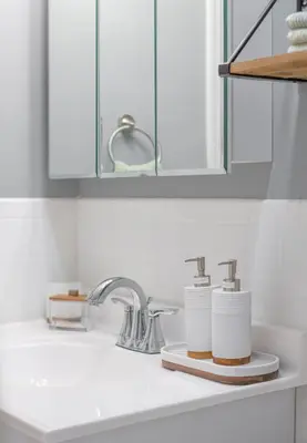 a bathroom sink with two soap dispensers on it at Cozy Home, 17 min from NYC, 2 Parking Spaces in Ridgefield Park