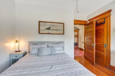 a bedroom with a bed and a picture on the wall at 6 Mi to Montage Mtn Resort! Family Home with Yard in Scranton