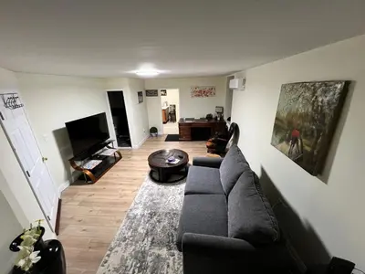 a living room with a couch and a table at Your Comfortable Home Away From Home in North Bergen