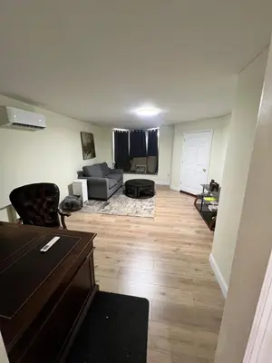 a living room with a couch and a table at Your Comfortable Home Away From Home in North Bergen