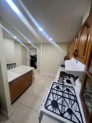 a kitchen with a stove and a counter top at Your Comfortable Home Away From Home in North Bergen