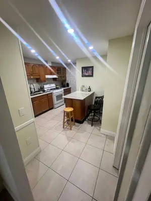 a kitchen with a table and chairs in a room at Your Comfortable Home Away From Home in North Bergen