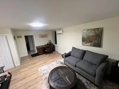 a living room with a couch and a table at Your Comfortable Home Away From Home in North Bergen
