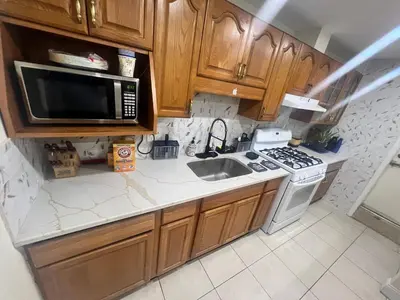 a kitchen with a sink and a microwave at Your Comfortable Home Away From Home in North Bergen