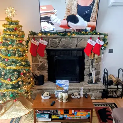 a living room with a christmas tree and a fireplace at Hideout Pocono Chalet in Lake Ariel