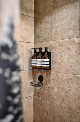 two bottles of beer on a wall in a shower at Hideout Pocono Chalet in Lake Ariel