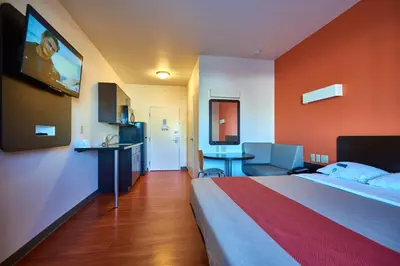a hotel room with a large bed and a flat screen tv at Motel 6 Wilkes Barre Arena in Wilkes-Barre