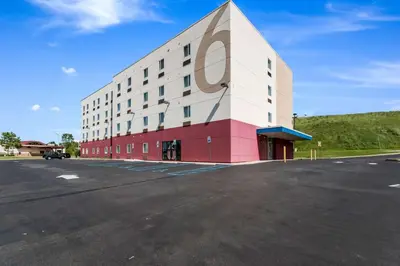 a building with a parking lot in front of it at Motel 6 Wilkes Barre Arena in Wilkes-Barre