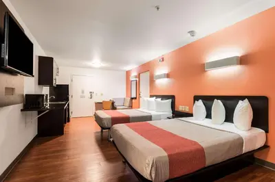 a hotel room with two beds and a television at Motel 6 Wilkes Barre Arena in Wilkes-Barre