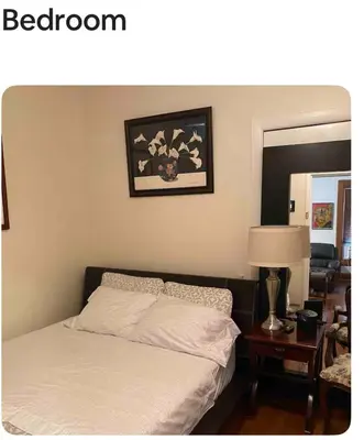 a bedroom with a bed and a picture on the wall at Cozy apartment in Brooklyn