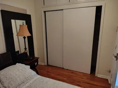 a bedroom with a bed and a sliding glass door at Cozy apartment in Brooklyn
