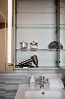 a bathroom with a sink and a stove at Modern Designer Stunning Hudson Views Corner Unit in New York