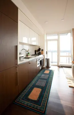 a kitchen with a rug in the middle of a room at Modern Designer Stunning Hudson Views Corner Unit in New York