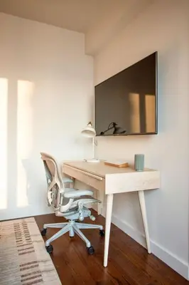 an office with a desk and a chair and a mirror at Modern Designer Stunning Hudson Views Corner Unit in New York