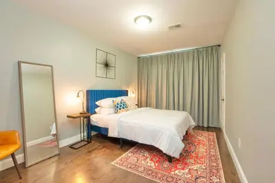 a bedroom with a white bed and a rug at Sky Walk at The Hillside in Newark