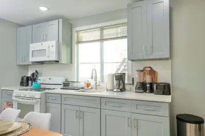 a kitchen with white cabinets and a counter top at Sky Walk at The Hillside in Newark