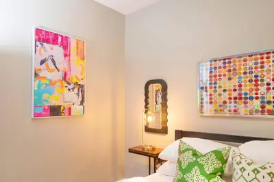 a bedroom with a bed and a mirror on the wall at Sky Walk at The Hillside in Newark