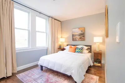 a bedroom with a white bed and a window at Sky Walk at The Hillside in Newark