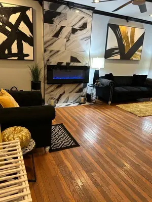 a living room with black furniture and a wooden floor at Theres No Place Like Home in Philadelphia