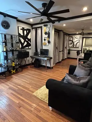 a living room with a couch and a ceiling fan at Theres No Place Like Home in Philadelphia