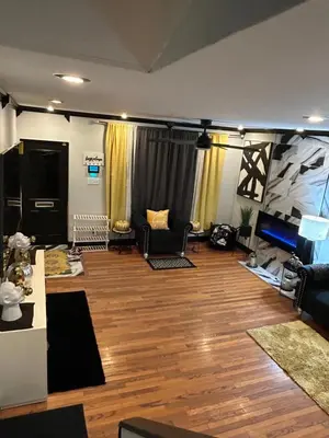 a living room with wood floors and a room with a couch at Theres No Place Like Home in Philadelphia