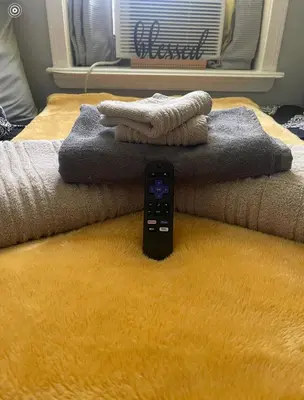 a remote control sitting on top of a bed at Theres No Place Like Home in Philadelphia