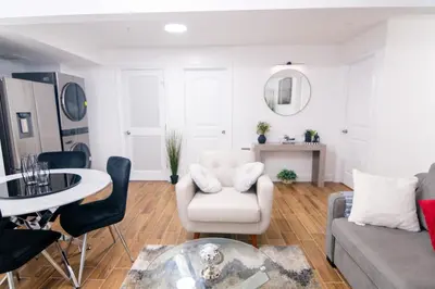 a living room with a couch and a table at BrightOAK Eloire-Private in Newark