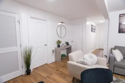 a living room with a couch and a chair at BrightOAK Eloire-Private in Newark