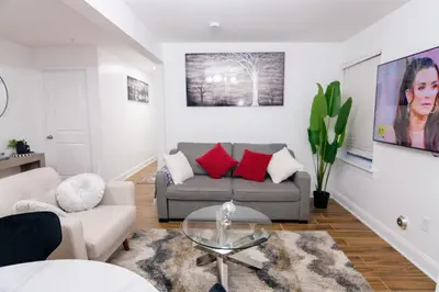 a living room with a couch and a table at BrightOAK Eloire-Private in Newark