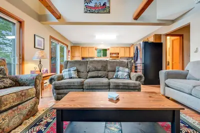 a living room with a couch and a table at beautiful lakefront lodge in Lake Harmony