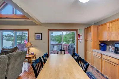 a kitchen and dining room with a table and chairs at beautiful lakefront lodge in Lake Harmony