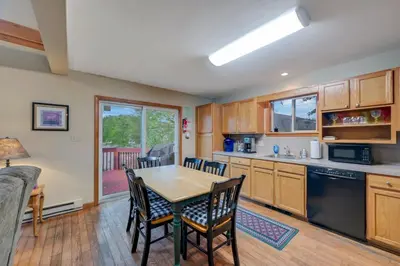 a kitchen with a table and chairs in a room at beautiful lakefront lodge in Lake Harmony