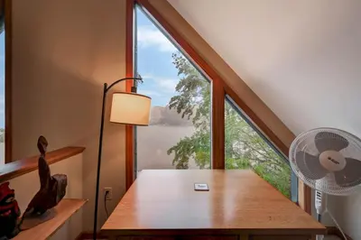 a room with a table and a large window at beautiful lakefront lodge in Lake Harmony