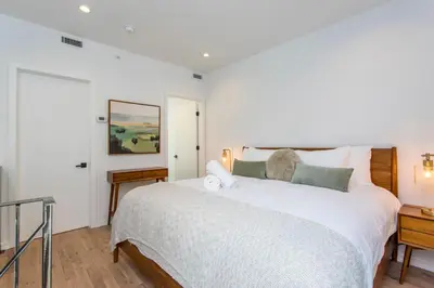 a bedroom with a large white bed and a window at Inventors Loft Luxury Upscale Quiet Two Bedroom in Philadelphia