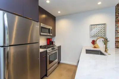 a kitchen with a stainless steel refrigerator and a stove at Inventors Loft Luxury Upscale Quiet Two Bedroom in Philadelphia