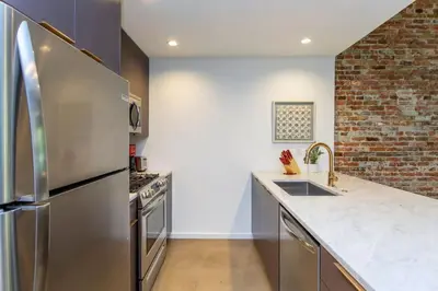 a kitchen with a stainless steel refrigerator and a sink at Inventors Loft Luxury Upscale Quiet Two Bedroom in Philadelphia