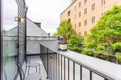 a balcony with two chairs and a table at Inventors Loft Luxury Upscale Quiet Two Bedroom in Philadelphia