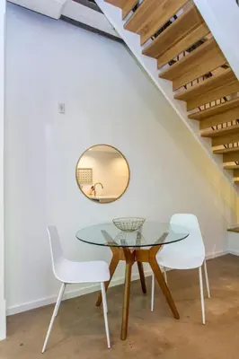 a dining room with a glass table and white chairs at Inventors Loft Luxury Upscale Quiet Two Bedroom in Philadelphia