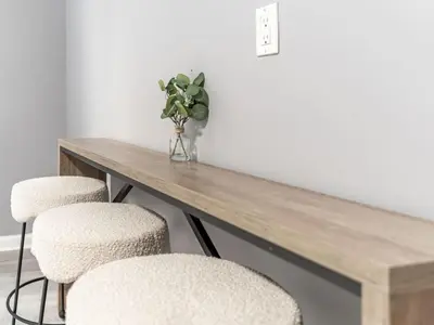 a table with three chairs and a vase with a plant at Cozy Modern Apt Close to NYC NO STEPS or Stairs in South Hackensack