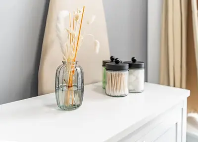 a glass vase with flowers on top of a table at Cozy Modern Apt Close to NYC NO STEPS or Stairs in South Hackensack