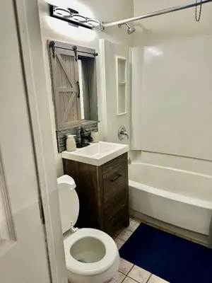 a bathroom with a toilet and a sink and a tub at Cozy Drexel Hill Retreat - Perfect for Families in Drexel Hill