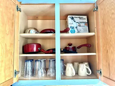 a cupboard with dishes and utensils in it at Cozy Drexel Hill Retreat - Perfect for Families in Drexel Hill