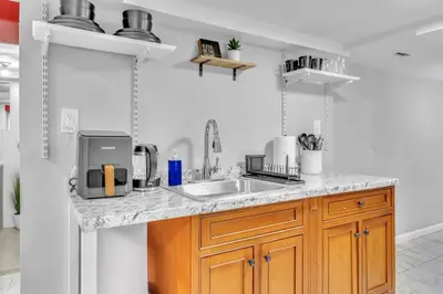 a kitchen with a sink and a counter top at Cozy Private Room in Shared Space NYC Light Rail in Bayonne