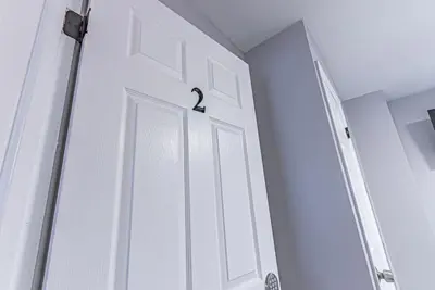 a white door with a handle on it in a room at 6Br 2bth NYC Penn Station NYC USA Mall EWR in Newark