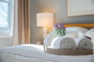 a hotel room with a bed with towels on it at NYC Skyline Views • Near Times Sq • Rooftop Deck in Jersey City