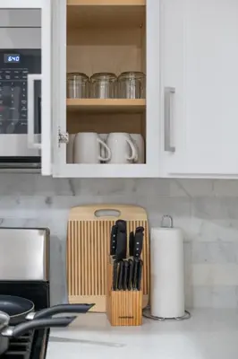 a kitchen counter with a cutting board and utensils at Modern Condo with Private Porch, Mins to NYC in Jersey City