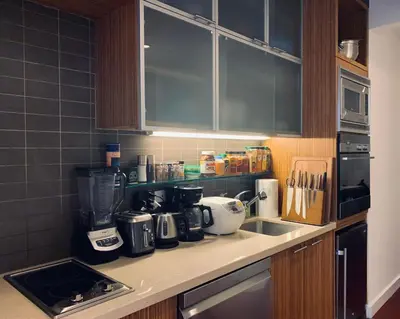 a kitchen with a counter top with a coffee maker at Entire luxury apt midtown with pool, gym, and sauna in New York