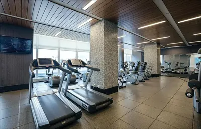 a gym with treadmills and ellipticals in a building at Entire luxury apt midtown with pool, gym, and sauna in New York