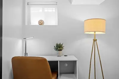 a desk with a chair and a lamp at luxury 2 bed 2 bath apt with free parking in Jersey City