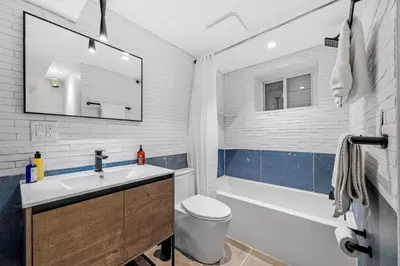 a bathroom with a sink and a toilet and a tub at luxury 2 bed 2 bath apt with free parking in Jersey City